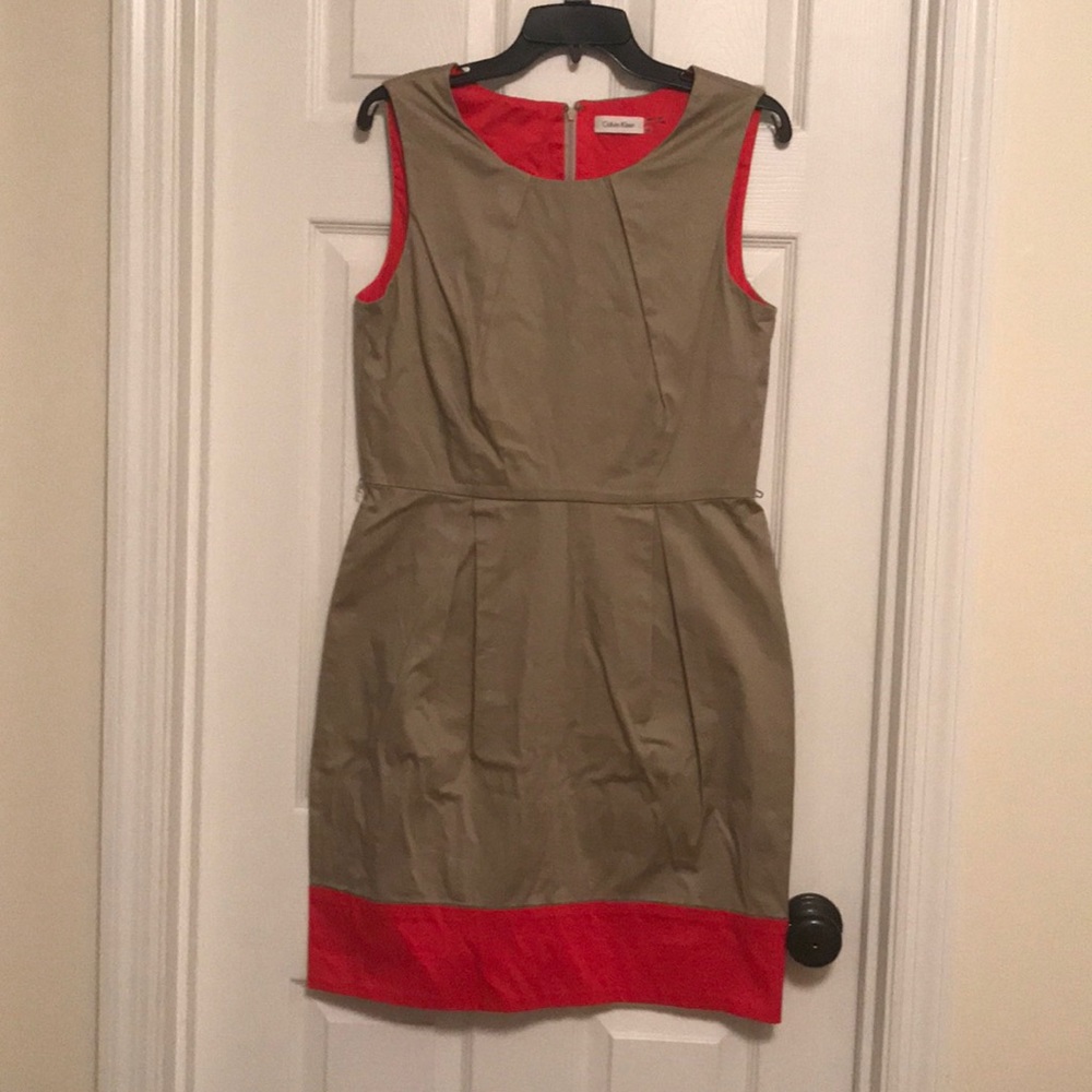 Tan cocktail dress with orange detail.